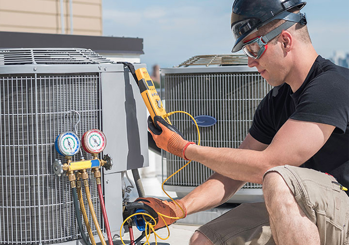 Technician Performing AC Repair Service in Brookshire TX on Rooftop Unit